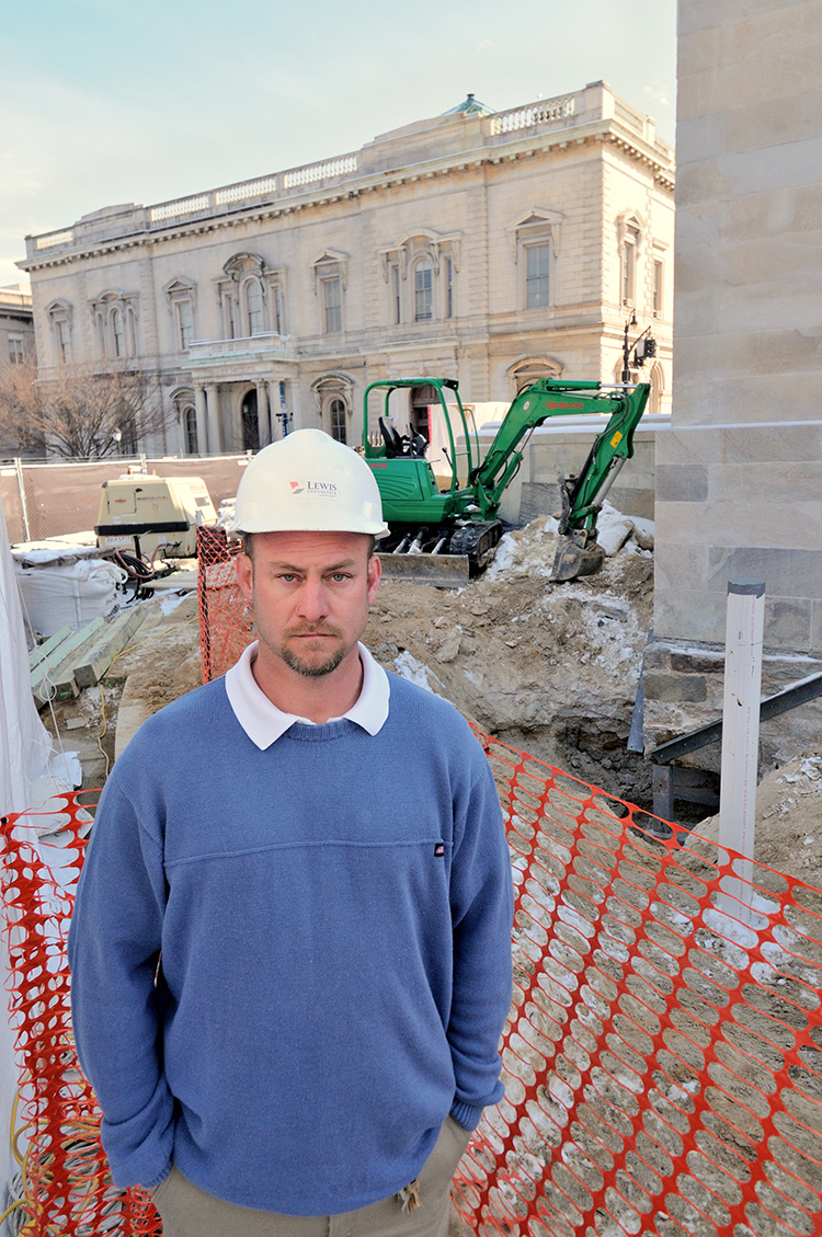 Man of the hour – George Wilk – helped discover both the 1815 and the 1915 time capsules. The original resting place of the northeast cornerstone at the base of the monument is seen in the background.